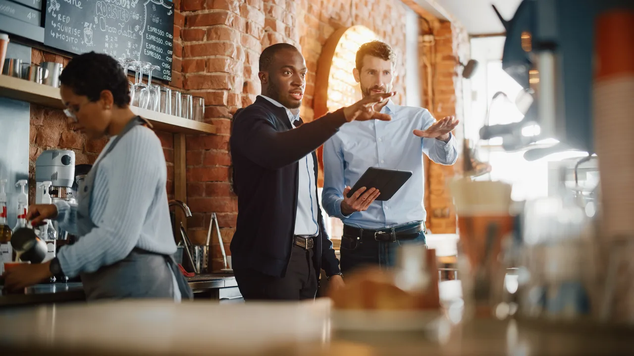 Two business partners discussing plans in a cafe