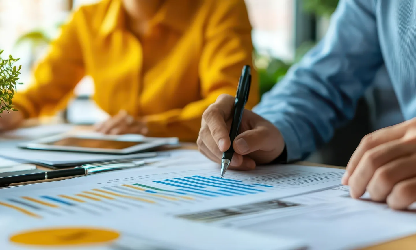 A pen tracing figures on a financial report